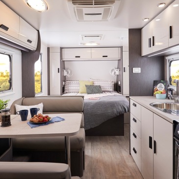 well organized and clean RV with white furniture